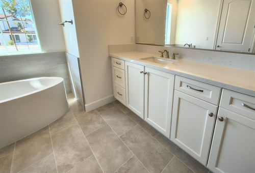 Quartz vanity and tile work installed by Mr. Tom's.