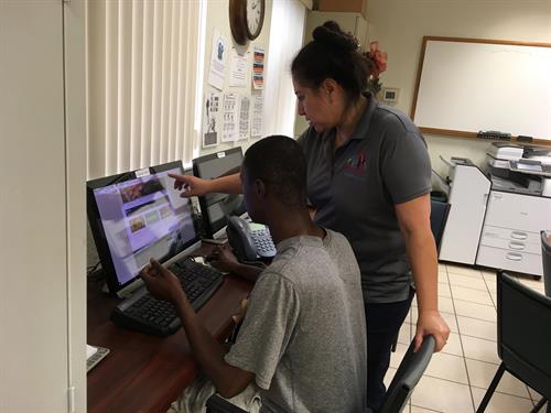 Our Family Assistance Coach helping a client perform a job search