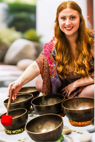 Madeline Rose, RYT-500, Founder with Himalayan Singing Bowls for a sound bath