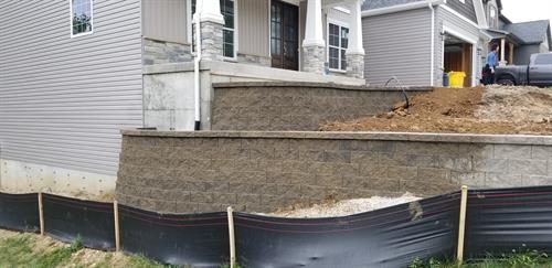 A two tier retaining wall with planter beds at the top.