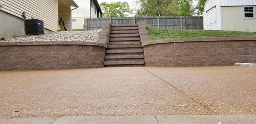 New retaining wall with steps to the top yard.