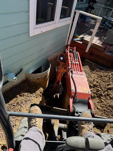 Excavating next to a foundation.
