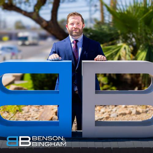 At Benson & Bingham’s Downtown location, attorney Jordan Kingsley stands by the firm’s logo, representing clients in a wide range of injury cases