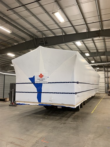 Modular House Wrapped for Delivery