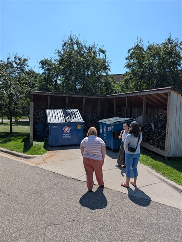 Sustainability Specialist discusses dumpster set-up with church