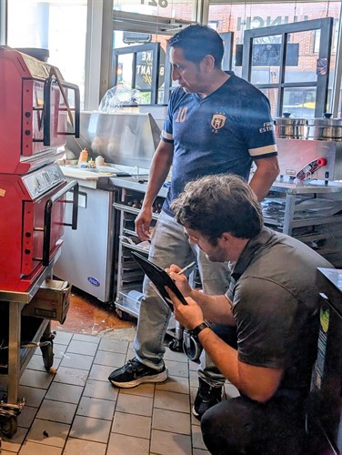 Energy Efficiency Specialist inspects food service equipment