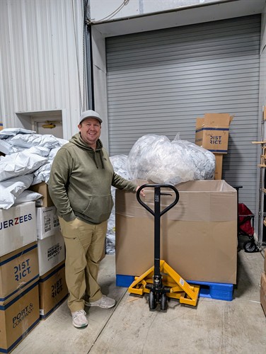 Business owner shows off his new pallet jack for assisting plastic film collection. 