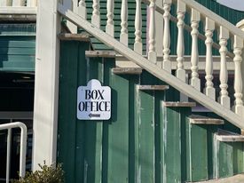 A photo of the Box office sign on the Hall building. 