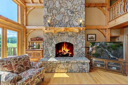 Stack stone fireplace in this timber frame lodge!