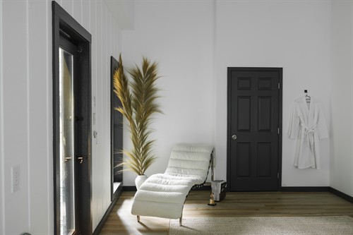 Our primary bedroom featuring a private porch with direct views of the Toccoa River from every window. Designed in a modern, minimalist wabi-sabi style that blends natural textures with calming simplicity.
