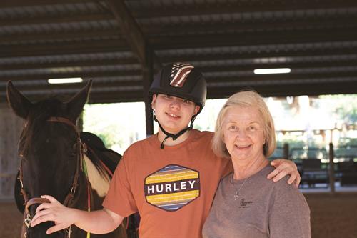 Client, Eli, in Therapeutic Riding Program with Volunteer