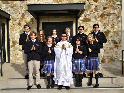 Father Wayne Ly from St. Martha's in Kingwood and students from St. Martha's Catholic School