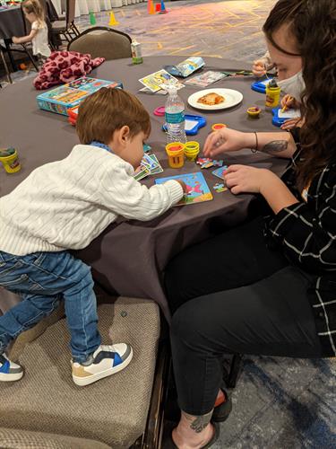 Playing a puzzle during a Providence wedding event providing childcare.