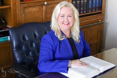 "Lady Lawyer" Cynthia Rignanese in the library at the Winter Haven Headquarters of the Law Firm