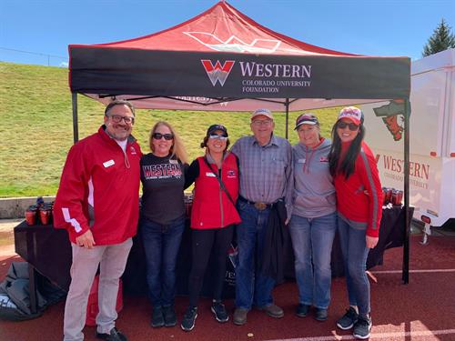 Staff at Homecoming football game 2021 with Jim Gelwicks
