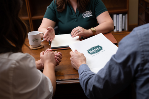 Close up photo of a family in Tahlequah Oklahoma taking out a home loan with the Bank of Cherokee County. Close up photo of a family in Tahlequah Oklahoma taking out a home loan with the Bank of Cherokee County.
