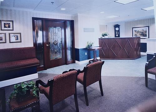 Law office with custom bench, stainglass soundproof door to confernce room, reception desk, and pocket door.