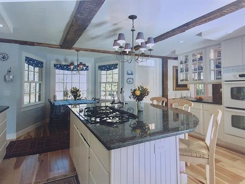 Antique vs modern home renovation-kitchen view with new island and bump out to accomodate eat in kitchen table.