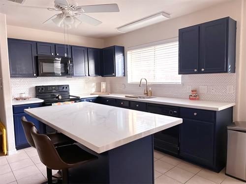 Splash of color, new countertops and new hardware was all that was needed to make this renovation happen.