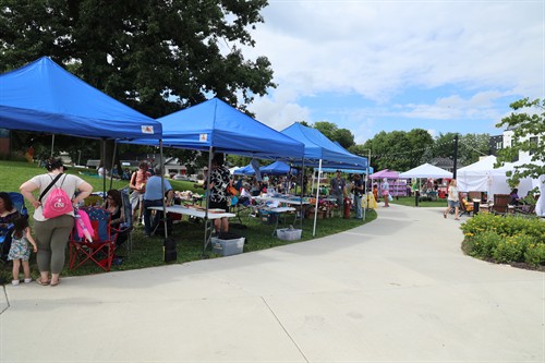 Vendor and sponsor tents at Community Day 2025