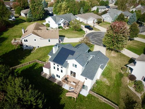 Aerial view showcasing integrated solar shingles on a modern Madison roof.