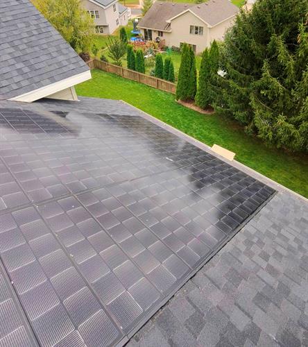 Close-up view of integrated Solstice solar shingles on a Moire Black Landmark Pro roof, delivering a sleek design and sustainable energy for this Madison West Side home.
