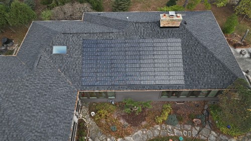 New roof with integrated solar shingles delivers a modern look and sustainable energy for this beautiful property.