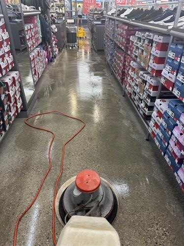 Machine Scrubbing a concrete floor at the Skechers in the Prime Outlet Mall