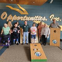 PremierBank Donates Cornhole Boards to Opportunities, Inc. in Support of Active, Healthy Living for Individuals of All Abilities