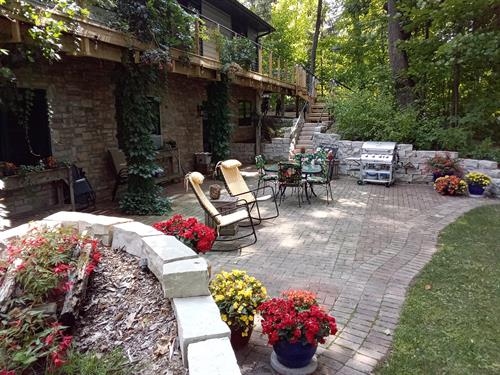 Private patio overlooking the Rock River and a gas grill.