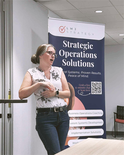 Laura in front of a room of small business owners discussing CRM platforms and their importance for entrepreneurs.