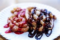 Try a funnel cake!  Choose your topping! Powdered sugar, strawberry sauce or chocolate!