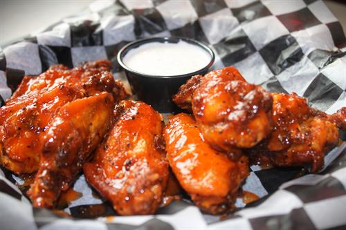 In-house smoked and seasoned chicken wings tossed in a sauce of your choice.