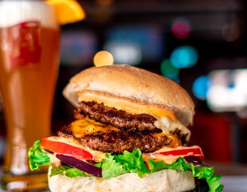 Delicious double patty burger paired with a tall Blue Moon.