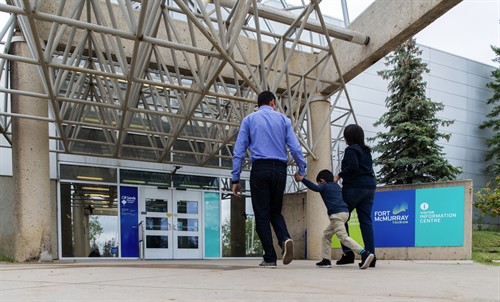 Family entering the Oil Sands Discovery Centre.