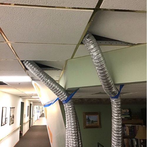 Drying ceiling tiles after sprinkler systems went off.