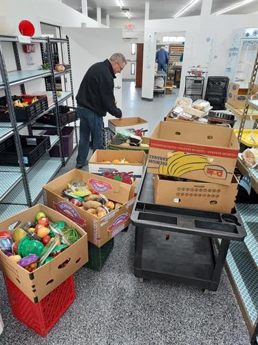 Volunteers working hard to sort and stock fresh produce