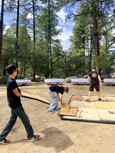 Co-Owner & Their Two Sons Setting Up The Copper Sky Glow Dance Floor 