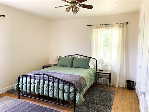 One of the two bedrooms included within the home, featuring a queen sized bed.