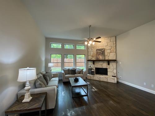 Hand scraped wood floors & stone fireplace with gas