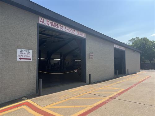 Side of the building with 2 of the 3 bay doors ajar. 