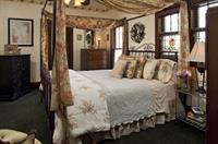Emily Dickinson's bedroom features  king semi-canopy bed