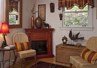 Oscar Wilde's den features a seasonal faux fireplace to enjoy when Autumn arrives in all her leafy splendor