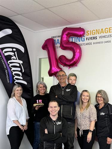 team celebrating 15years in business