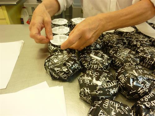 Wrapping and stickering cheese by h and