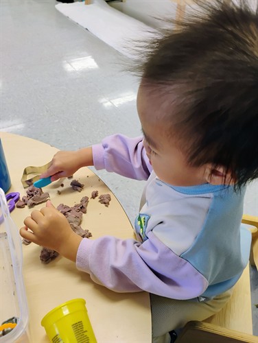 Even the youngest learners practice independence through meaningful, hands-on tasks.