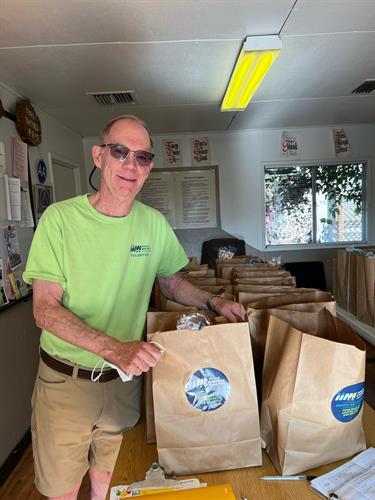 Volunteer deliving Grocery Bags to homebound seniors