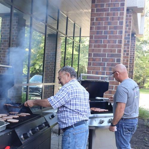 CEO & Chaplain captain the grills for an employee cookout.