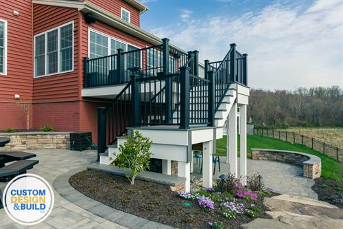 Trex Decking and Aluminum Railing, Dryspace system with soffit ceiling, Hardscape patio and bluestone walkway, Fire pit with boulder seating and stairs