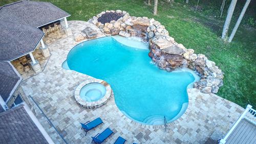 Full Outdoor Living Space with Pebbletec Pool, Waterfalls, Tanning Ledge, Spa with Spillover Feature, Travertine Decking, Pavilion with Outdoor Kitchen and Fireplace. 